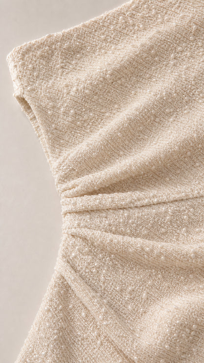 Close-up detail of textured fabric and side ruching
