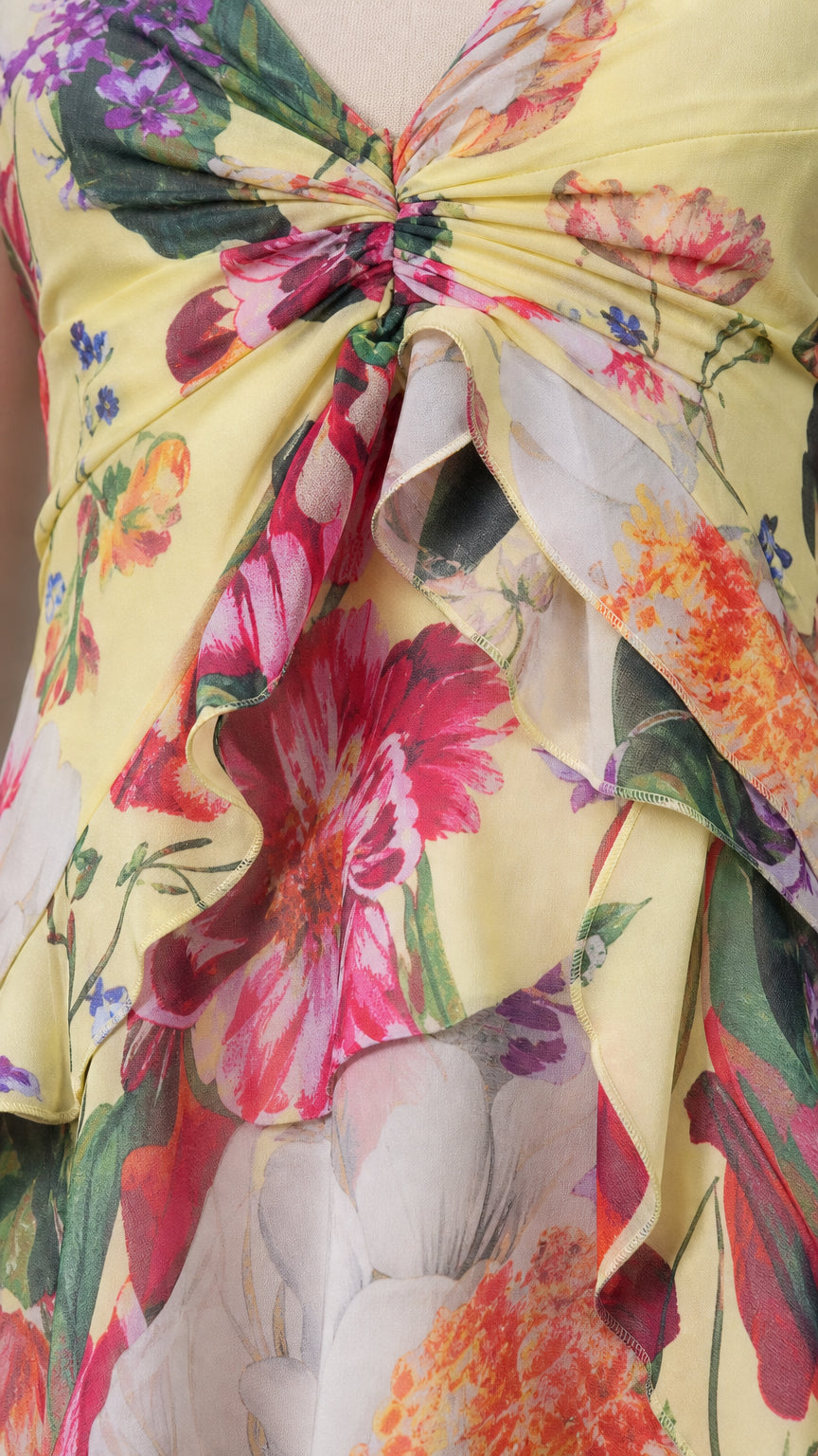 Close-up detail of twist-front bodice and ruffles on floral dress