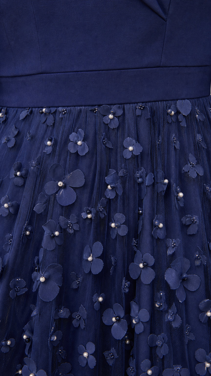 Close-up of 3D floral appliques and pearl details on Navy Blue skirt