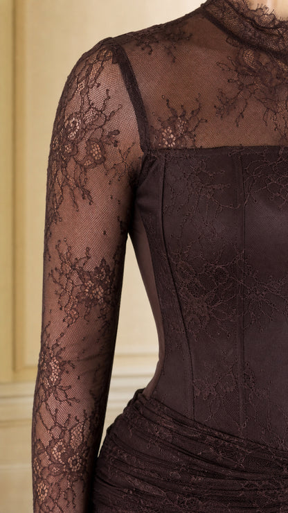 Close-up of sheer lace sleeve and structured bodice detail