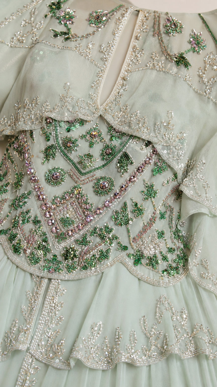 Close-up detail of intricate beadwork and embroidery on bodice