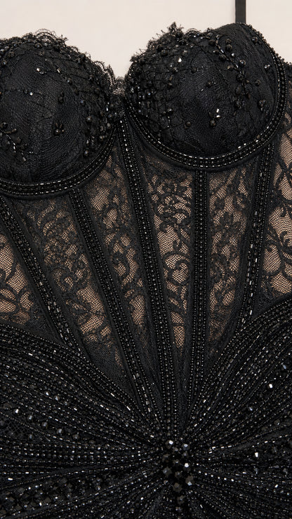 Close-up of intricate bodice beadwork and lace
