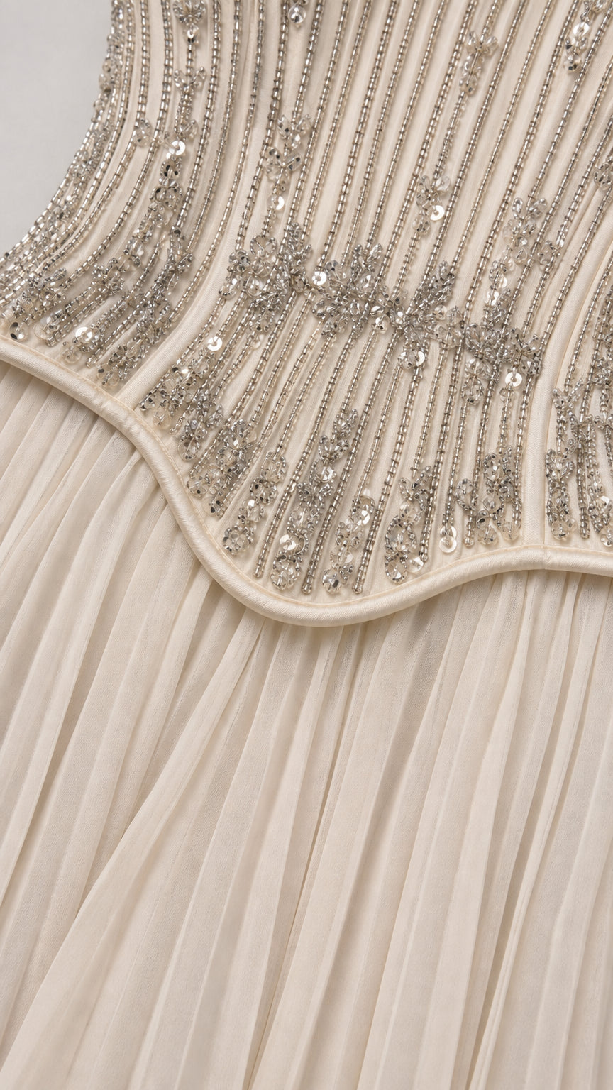 Close-up detail of beaded embroidery and pleating on corset waistline