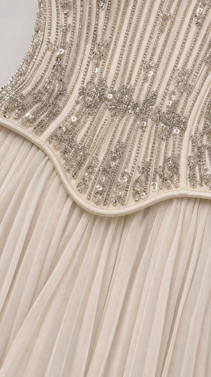 Close-up detail of beaded embroidery and pleating on corset waistline
