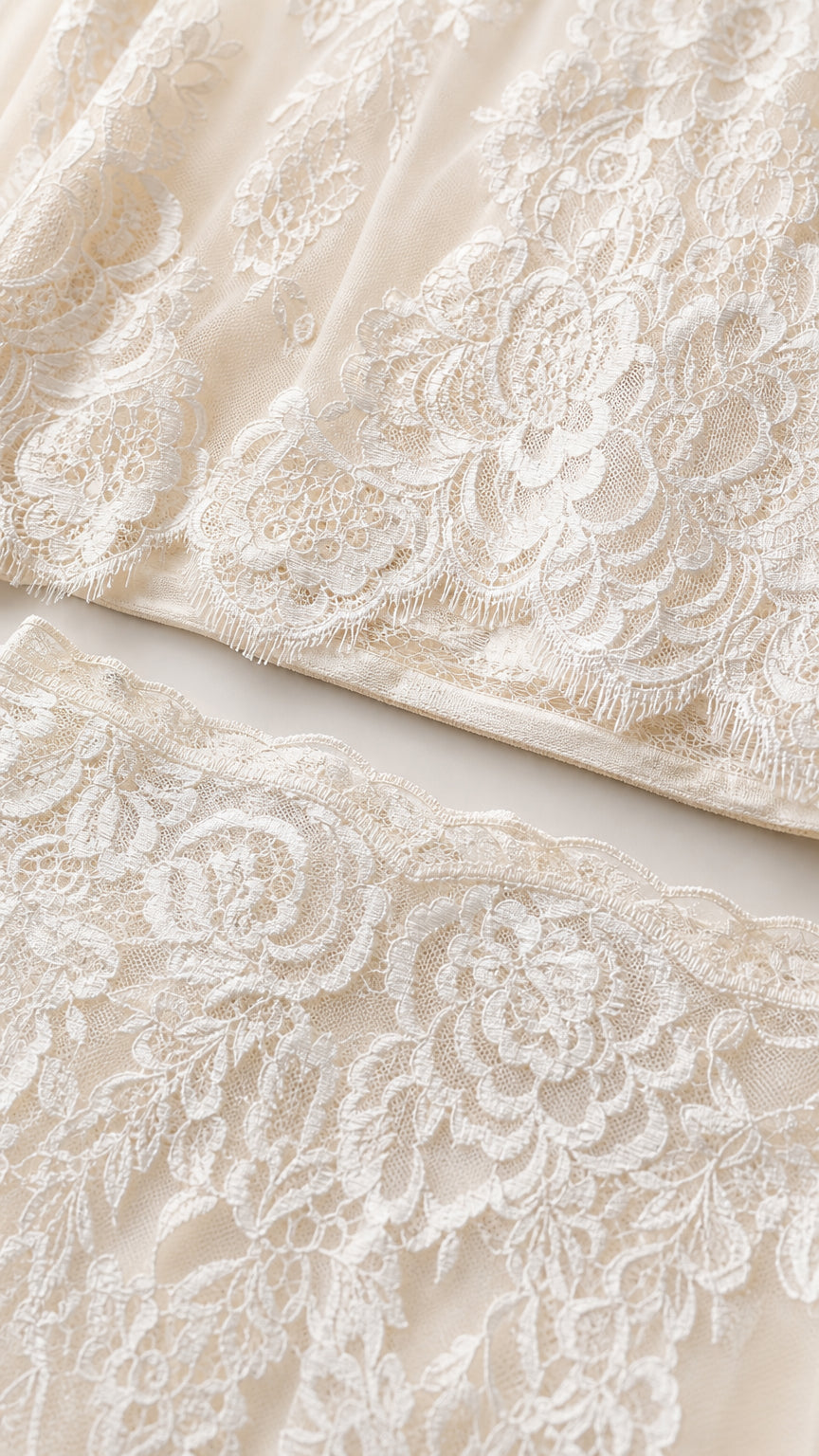 Close-up detail of white floral lace fabric and scalloped hem