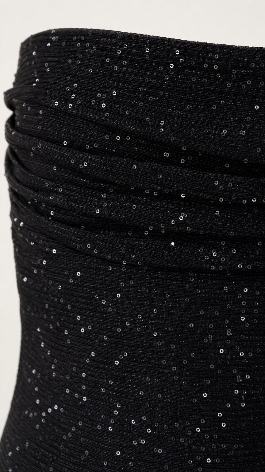 Close-up detail of black sequin textured fabric