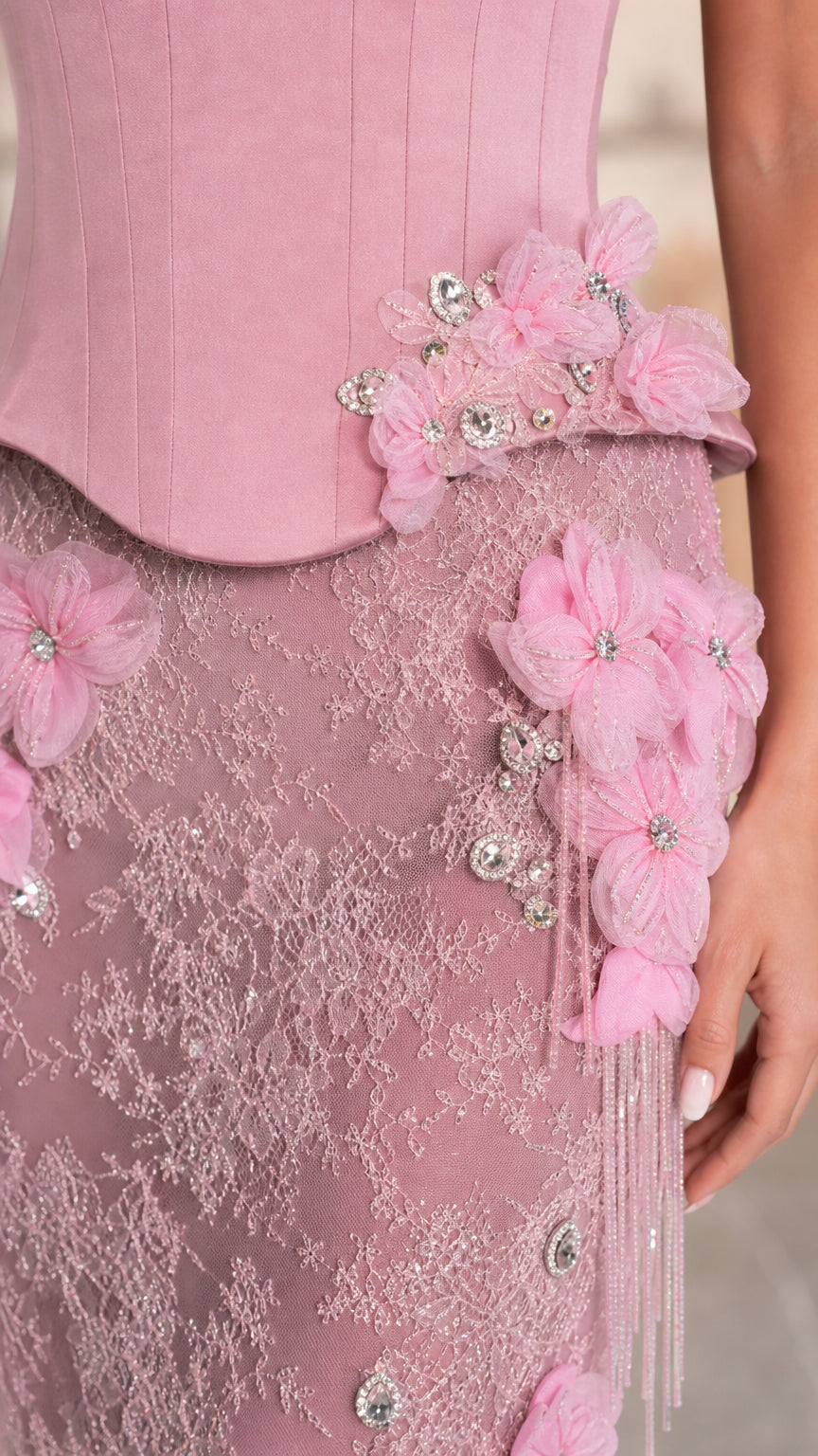 Close-up detail of 3D floral appliques, beading, and intricate lace fabric