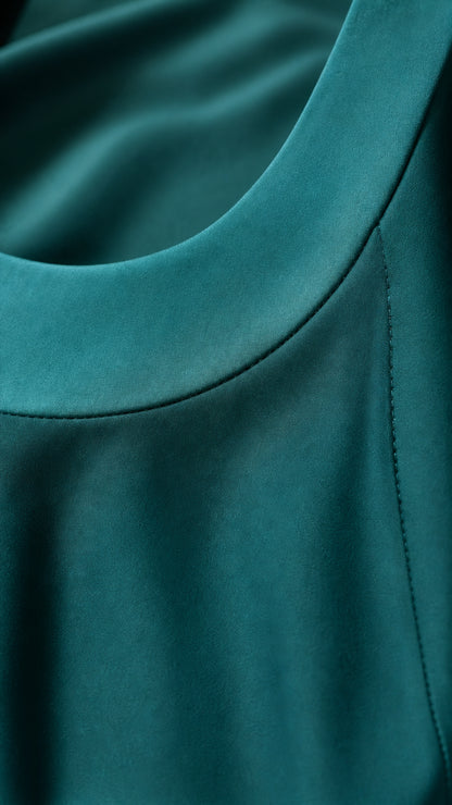 Close-up of fabric texture and neckline on teal maxi dress