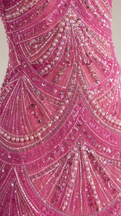 Close-up of intricate pink sequin and pearl beadwork pattern