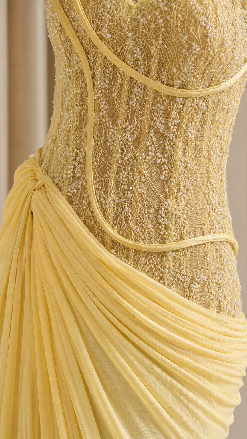Close-up of yellow lace corset bodice and draped fabric detail