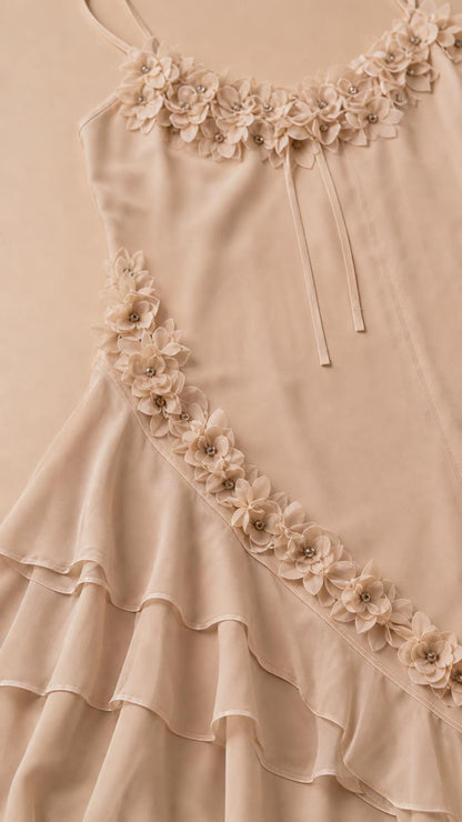 Close-up detail of 3D floral appliques and scoop neckline