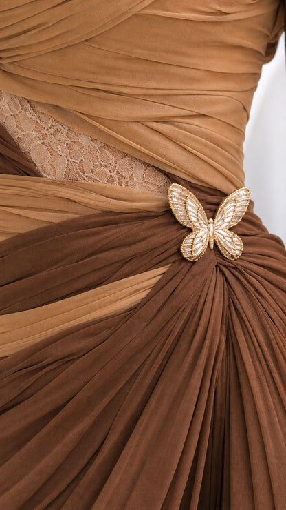 Close-up detail of pleated chiffon bodice, lace cutout, and gold crystal butterfly brooch