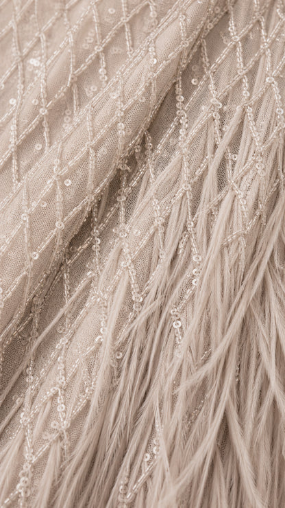 Close-up detail of sequin embroidery and feather texture