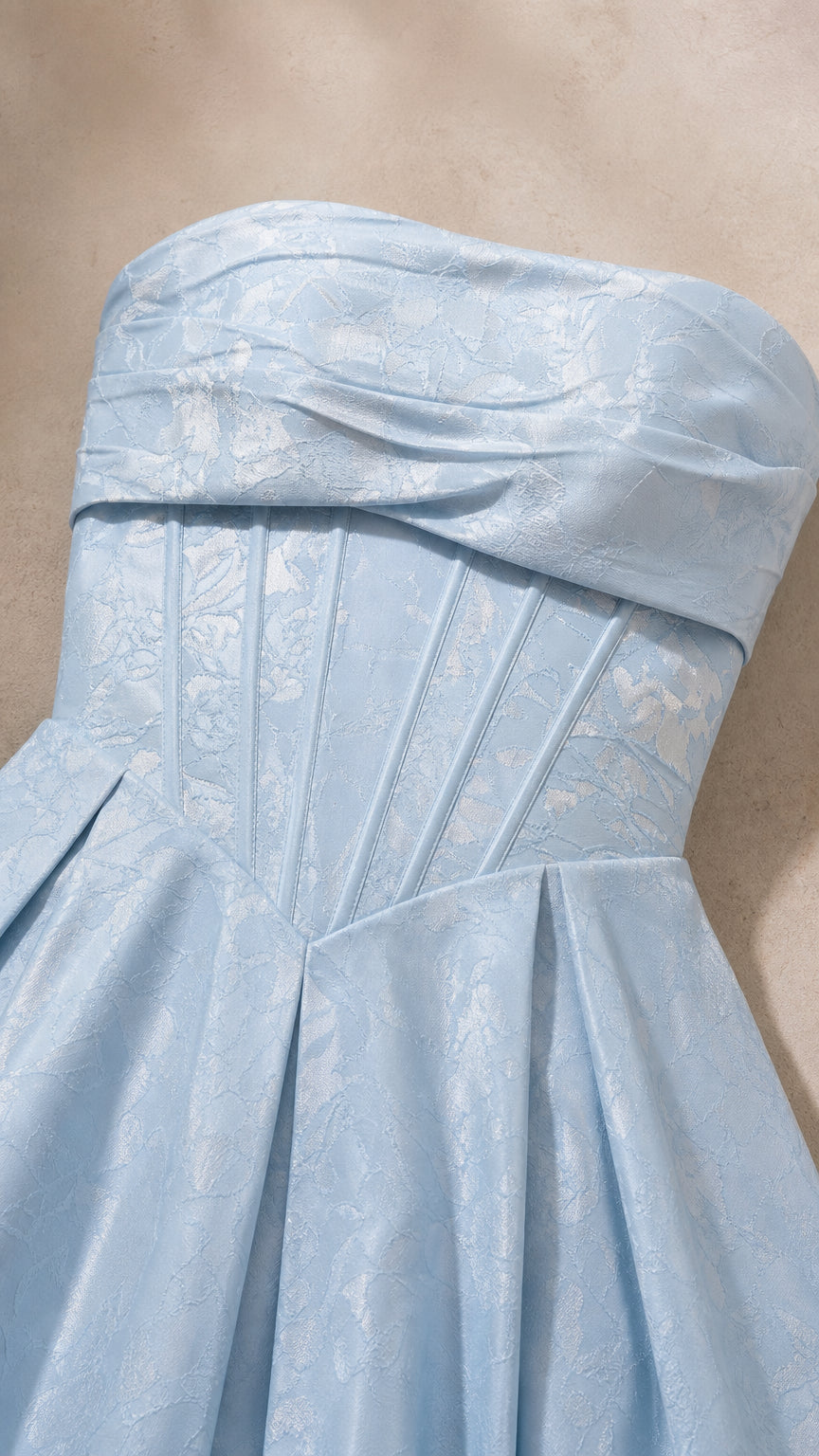 Close-up detail of light blue floral jacquard fabric and boned bodice construction