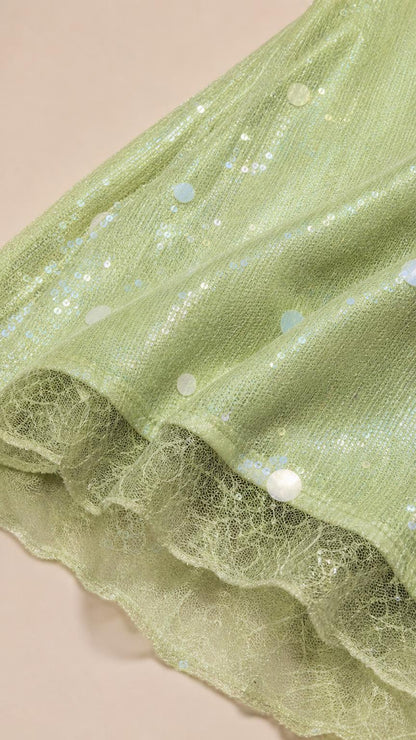 Close-up detail of textured mesh fabric and sequin polka dots