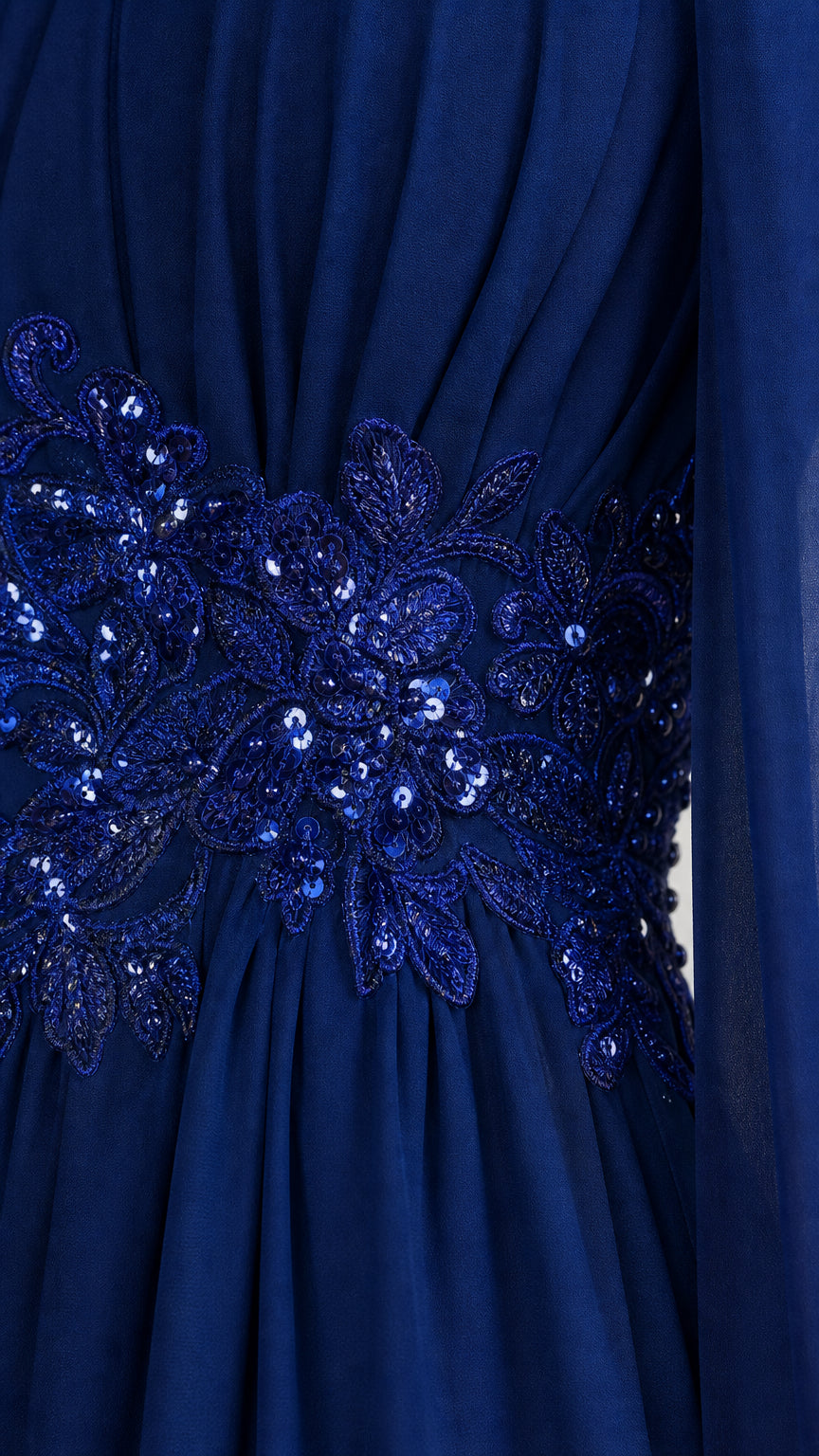 Close-up detail of sequin and floral embroidered waist on navy gown