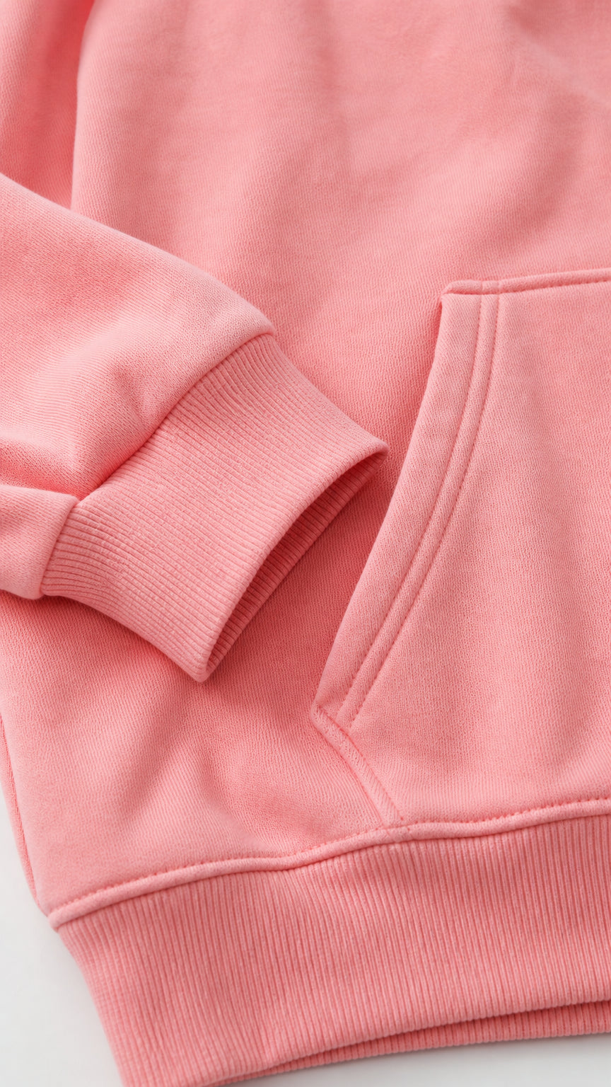 Close-up detail of pink hoodie kangaroo pocket and ribbed cuff