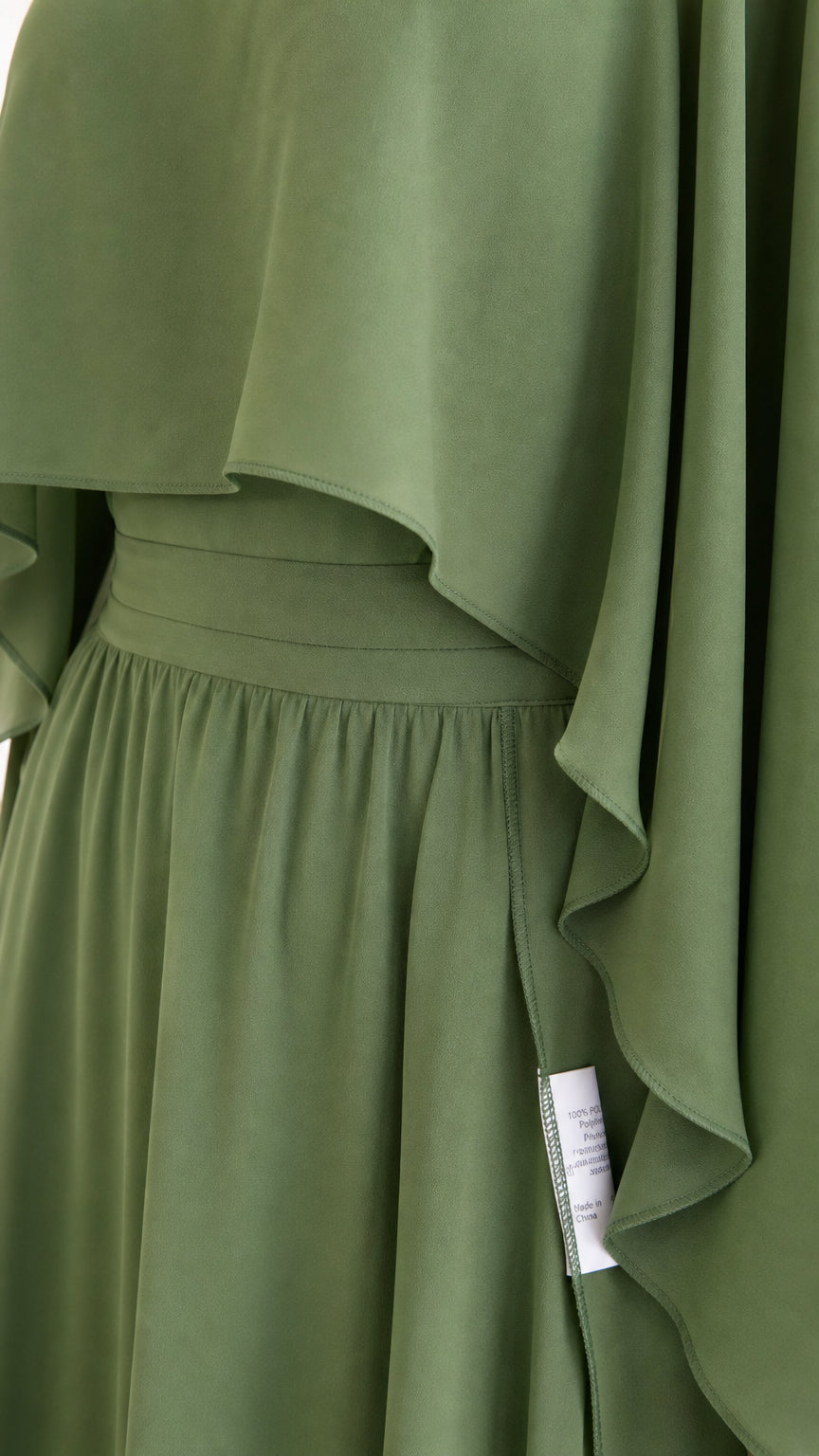 Close-up detail of fabric drape and waistband on olive green dress