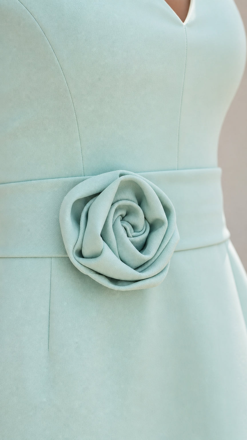 Close-up detail of the 3D rose applique on the dress waist
