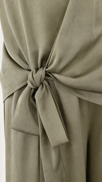 Close up of side tie detail on sage green satin pants