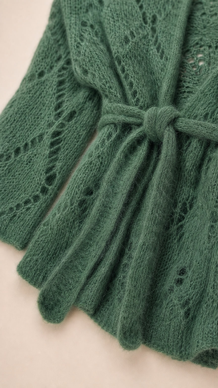 Close-up detail of green knit cardigan texture and tie belt