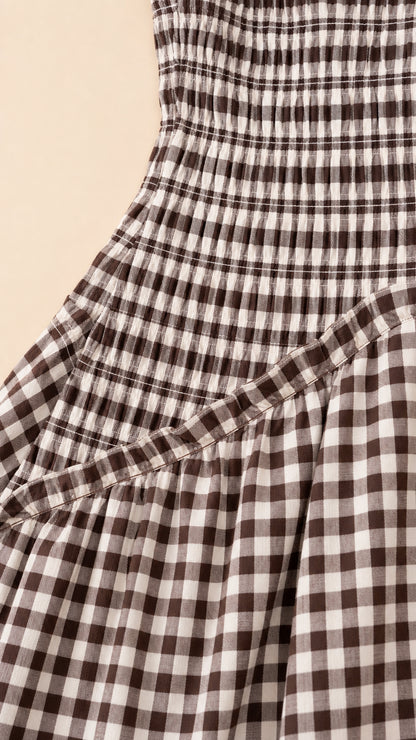 Close-up detail of smocked bodice and diagonal seam on gingham dress