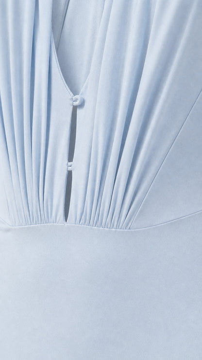 Close-up of ruched bodice and button detail on Light Blue dress