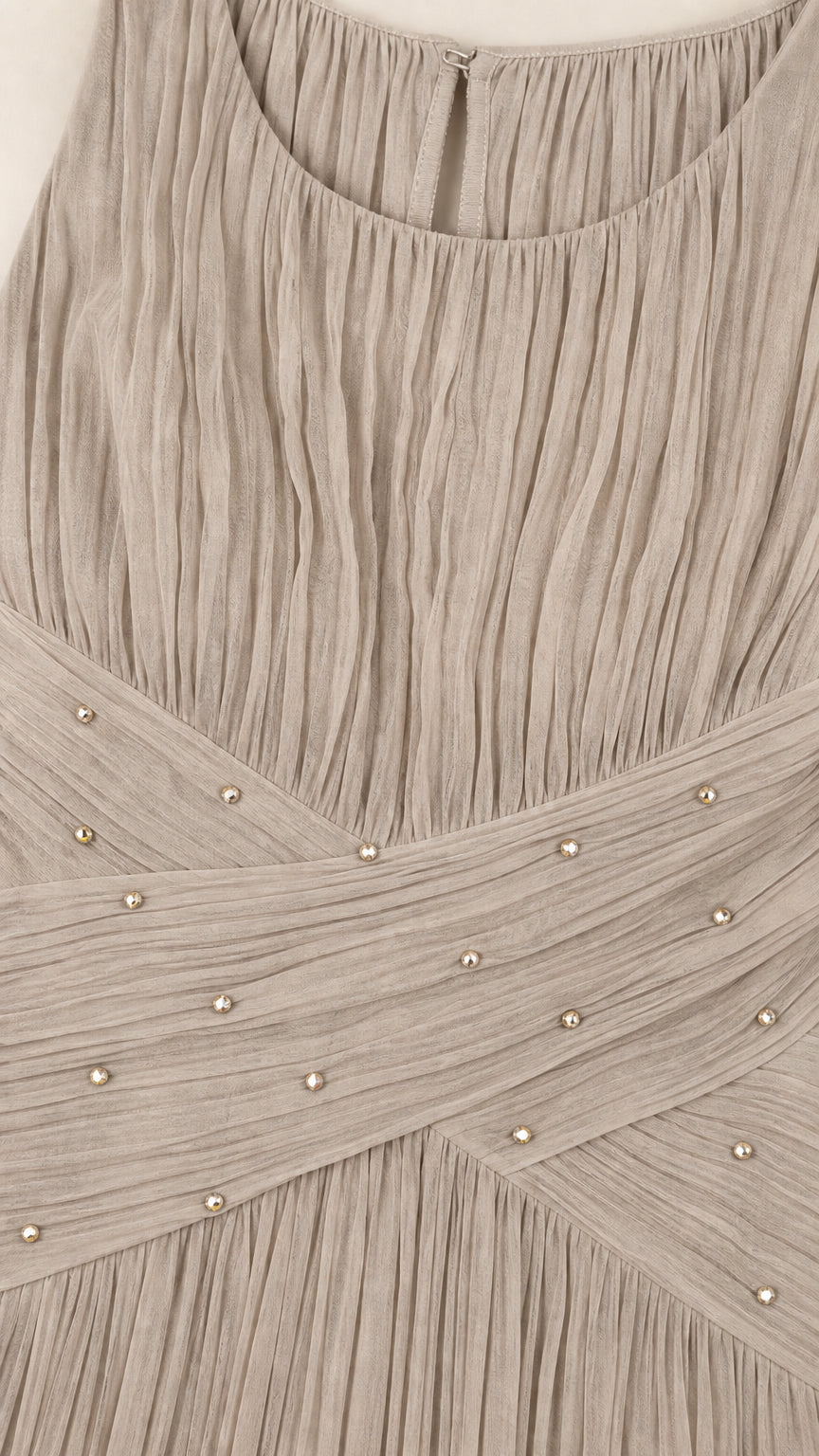 Close-up of pleated fabric and embellished crossover waist