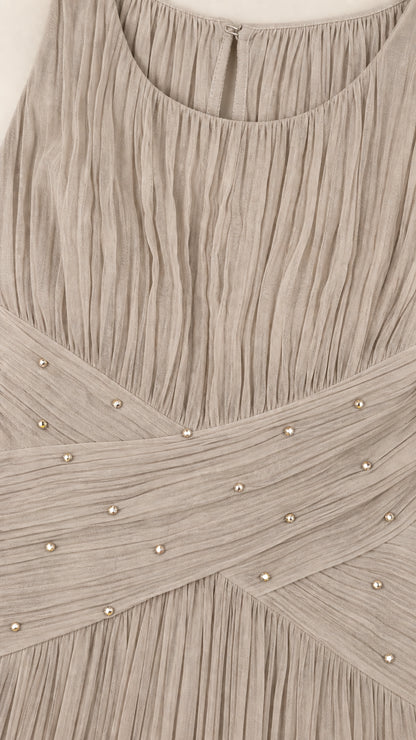 Close-up of pleated fabric and embellished crossover waist