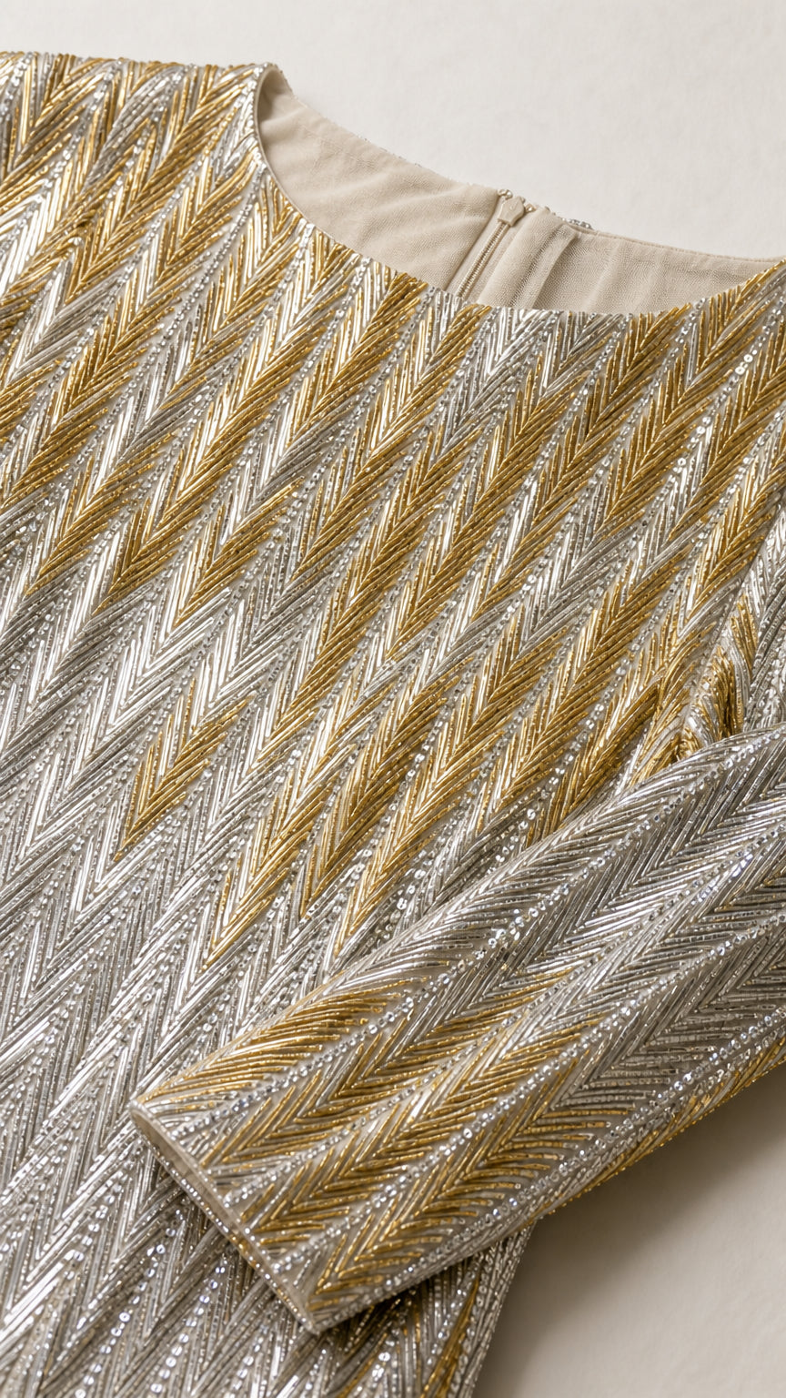 Close-up detail of neckline, cuff, and chevron sequin embroidery pattern