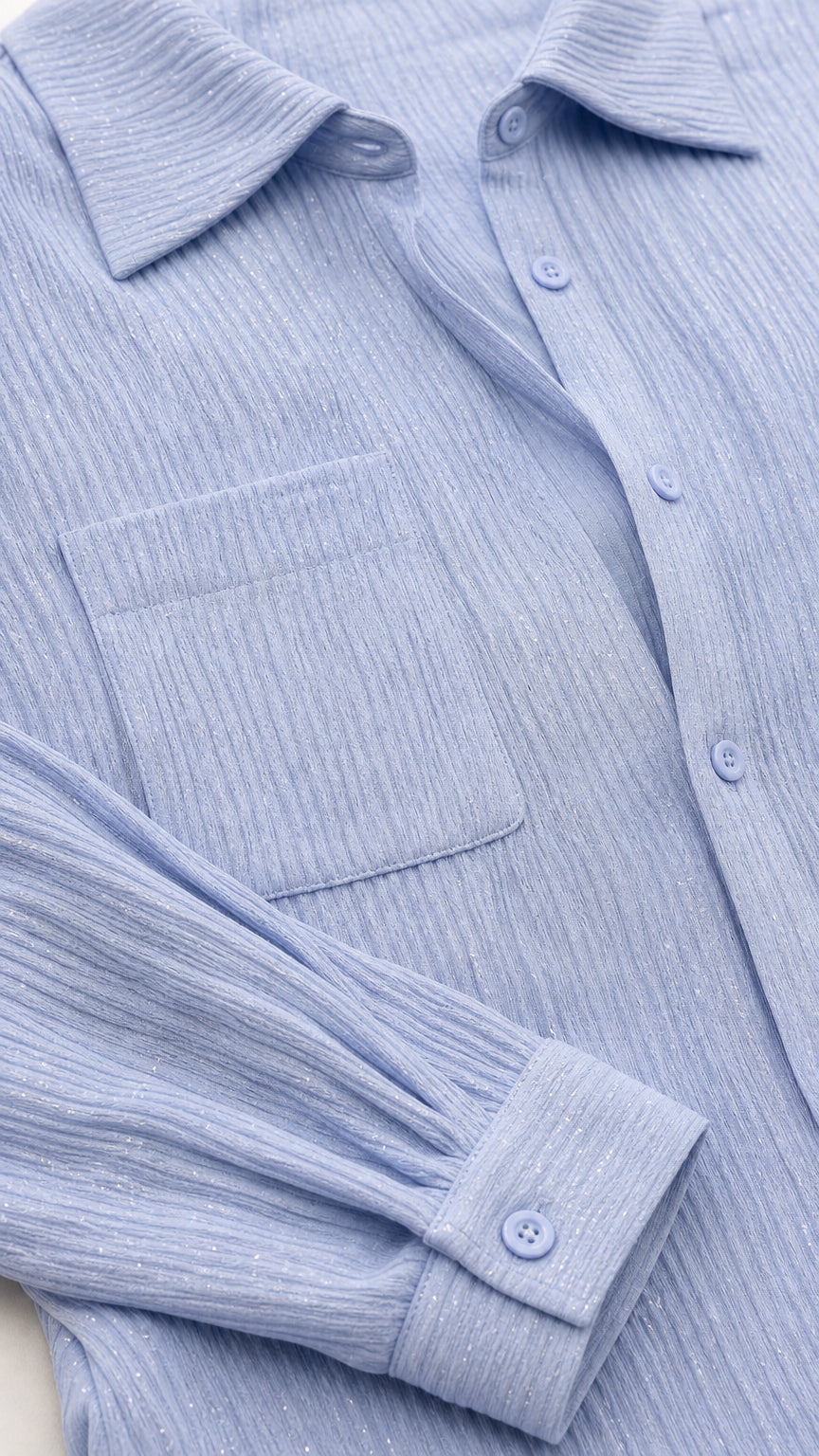 Close-up detail of lapel collar, button placket, chest pocket, and cuff
