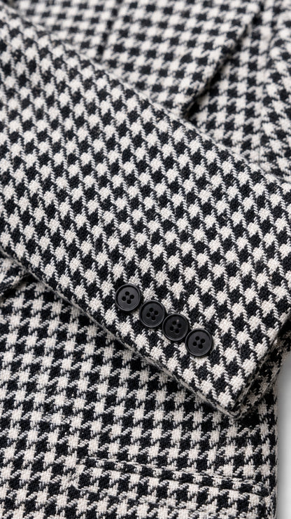 Close-up detail of houndstooth fabric and sleeve button accents