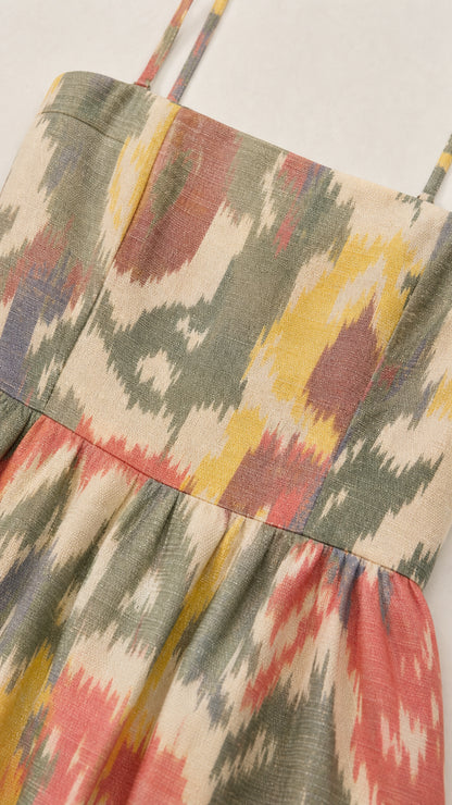 Close-up detail of textured woven fabric with colorful ikat print