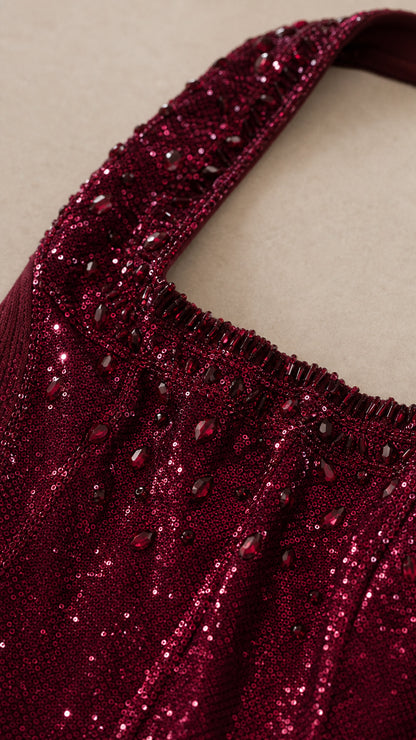 Close-up detail of sequin and bead embellishments on the neckline