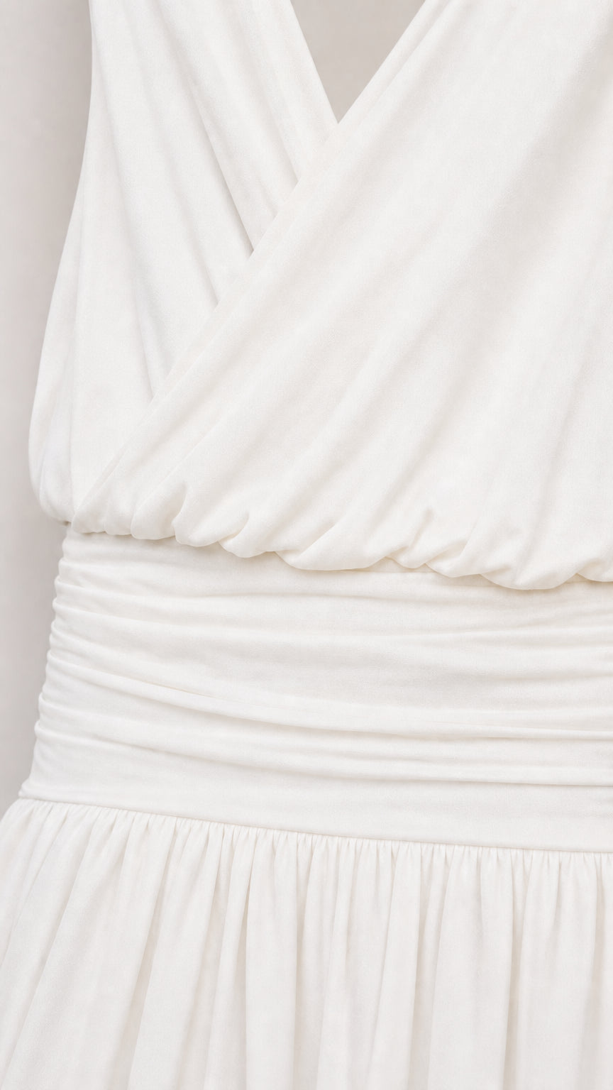 Close-up of draped surplice bodice and gathered waist
