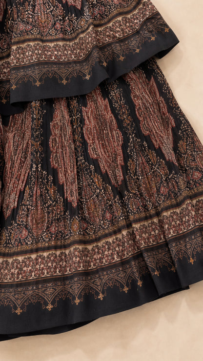 Close up of black printed fabric and tiered ruffle hem