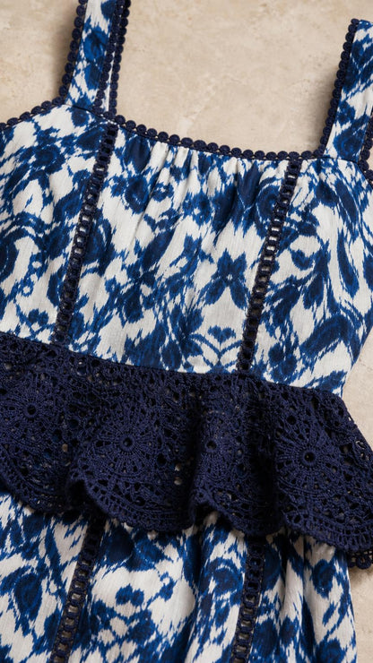 Close-up detail of square neckline and lace peplum waist on blue dress