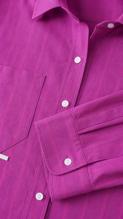 Close-up detail of fuchsia shirt collar, buttons, and pocket