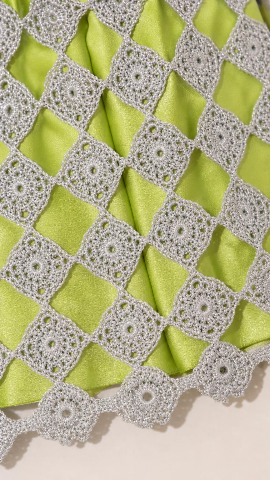 Close-up of lime green fabric and crochet texture detail