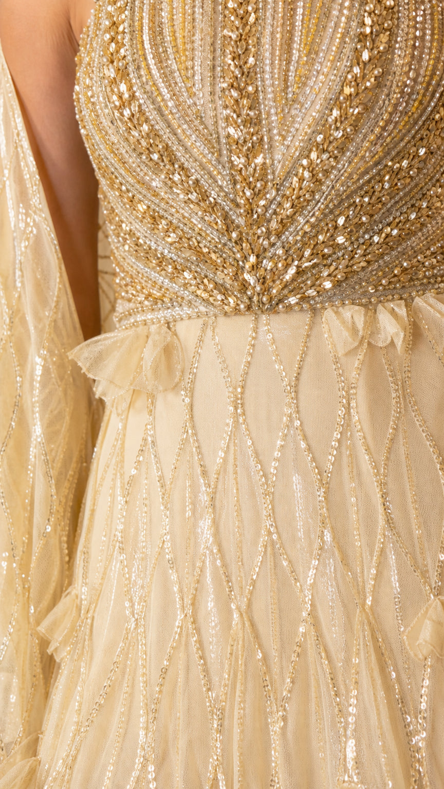 Close-up detail of the beaded bodice and sequin geometric skirt pattern