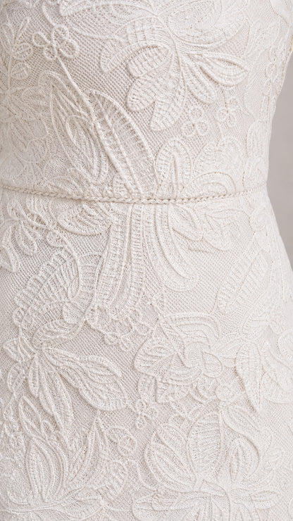 Close-up detail of White floral lace and waist trim