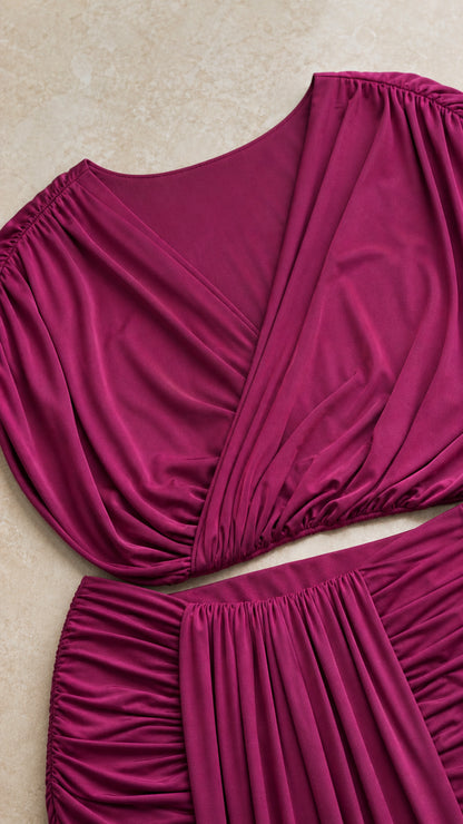 Close up view of the magenta crossover gathered bodice and ruched skirt fabric