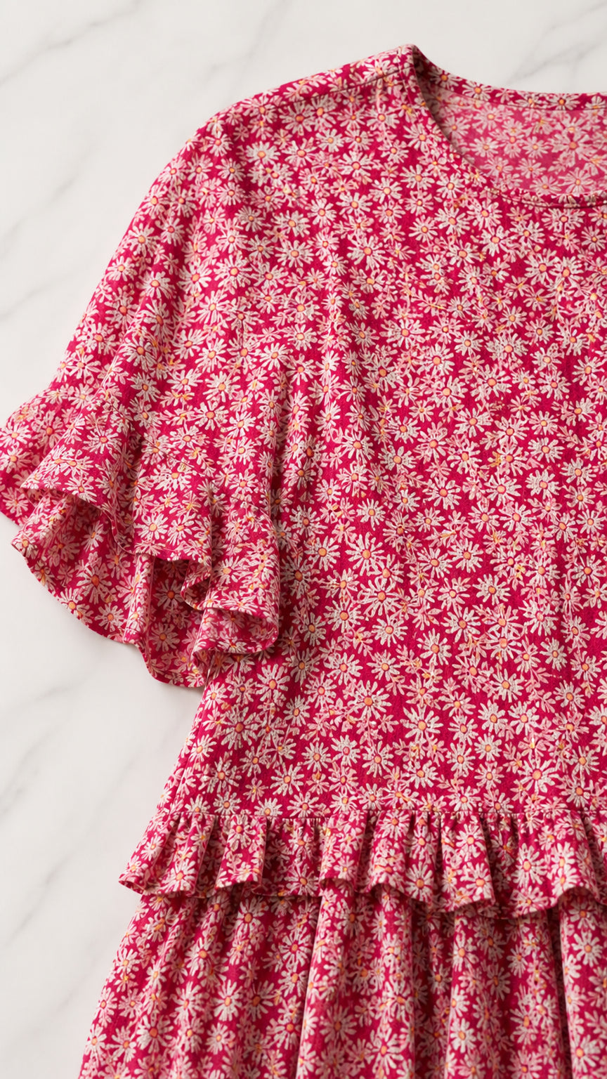 Close-up detail of Rose Pink ditsy floral print, ruffled sleeves, and hem finish