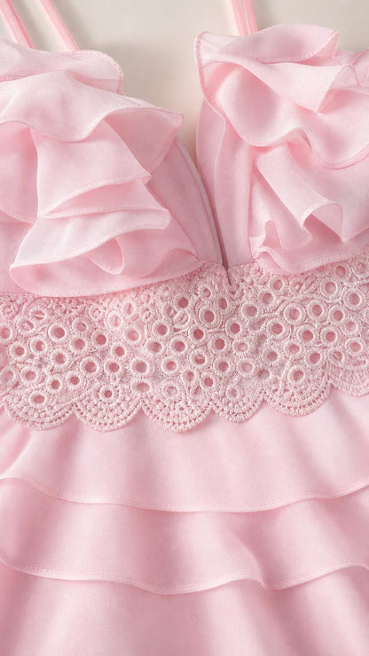 Close-up detail of bodice ruffles and lace trim in pink