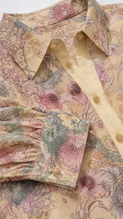 Close-up detail of collar, buttons, and floral cuff pattern