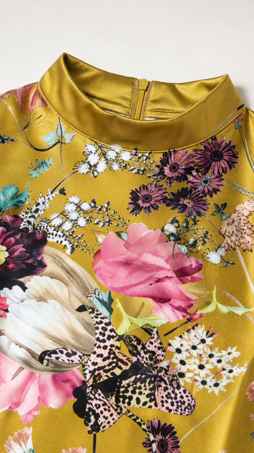Close-up detail of mock neckline and floral fabric pattern