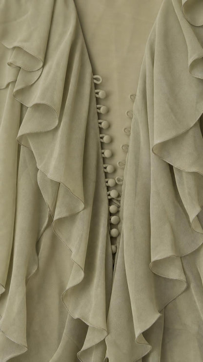 Close up of cascading ruffles and fabric buttons on Sage Green dress