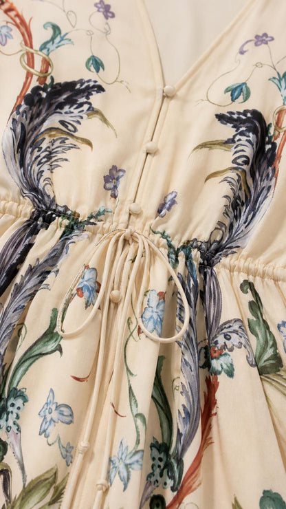 Close up of V-neck and drawstring waist on cream maxi dress