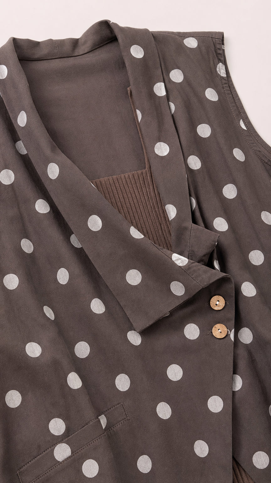 Close-up detail of brown polka dot vest lapel and buttons