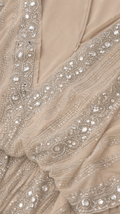 Close-up detail of rhinestone and sequin embellishments on champagne gown